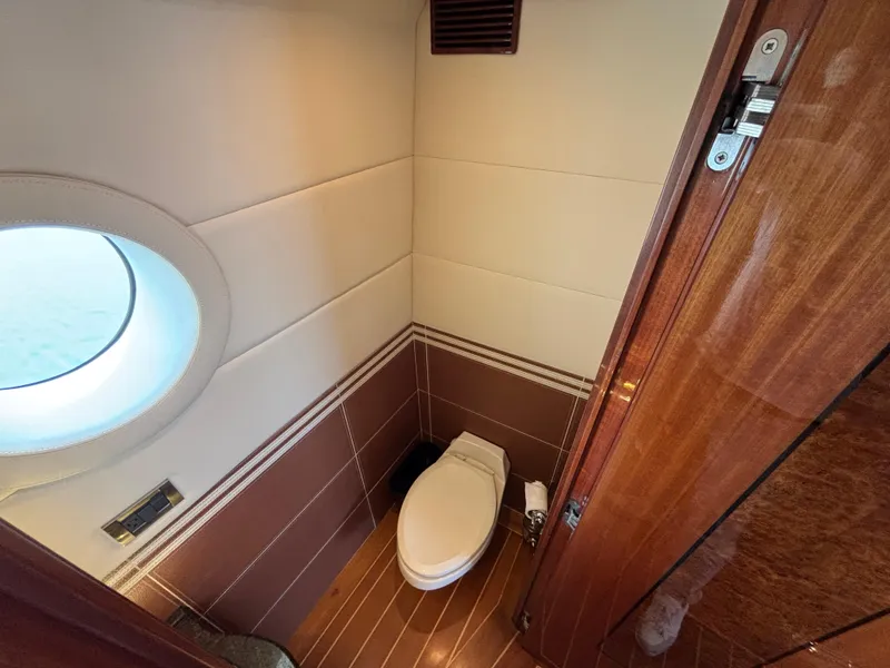 Slide: The Image of Luxurious Norseman 80 yacht bathroom with porthole, wooden accents, and modern fixtures, 2010 model. - 20