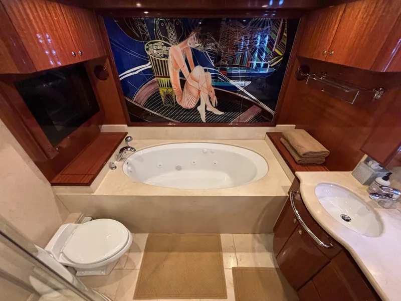 Slide: The Image of Luxurious Norseman 80 yacht bathroom with jacuzzi, elegant wood finishes, and artistic wall design. - 27