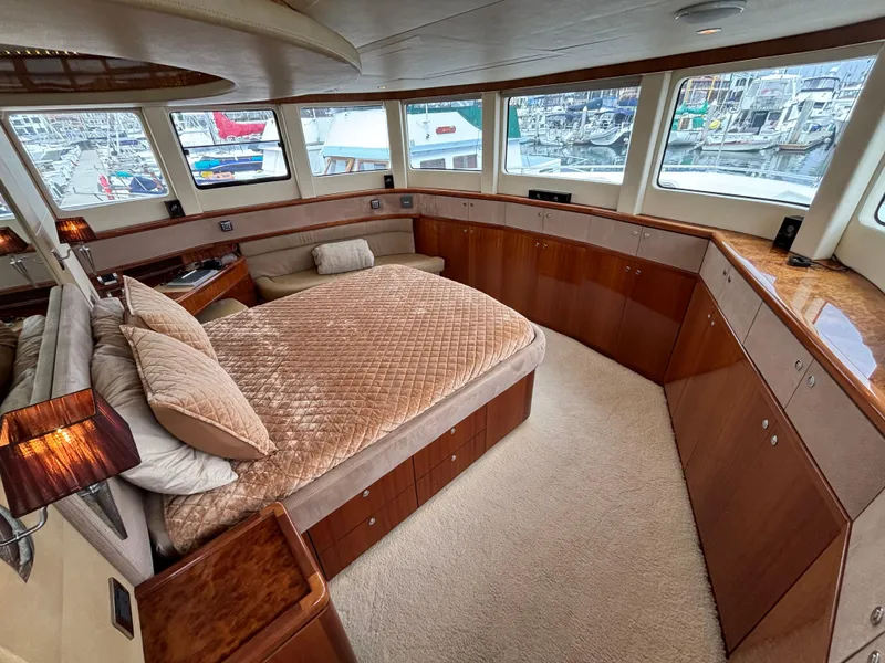 Slide: The Image of Luxurious Norseman 80 yacht bedroom interior with panoramic windows, plush bedding, and elegant wood finishes. - 31