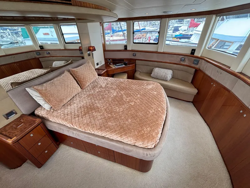 Slide: The Image of Luxurious bedroom interior of 2010 Norseman 80 yacht with plush bedding and panoramic windows. - 32
