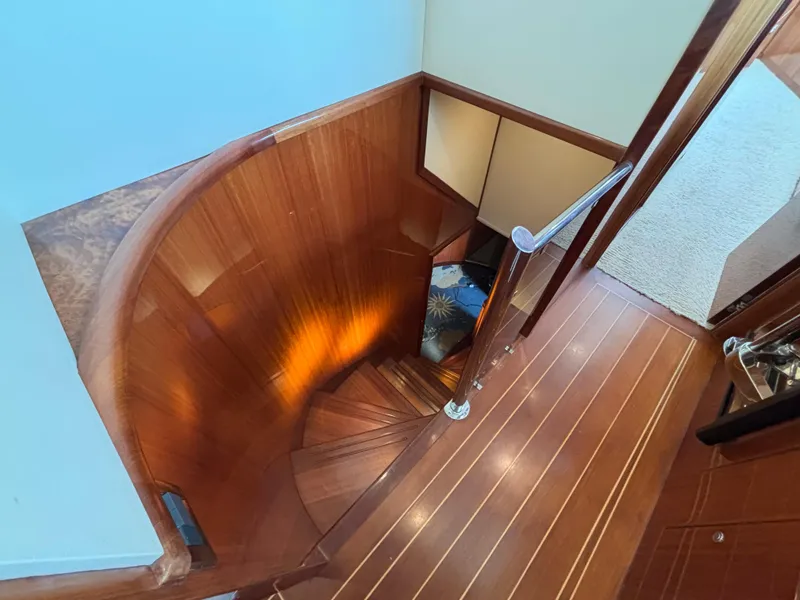 Slide: The Image of Curved wooden staircase on Norseman 80 yacht, 2010 model, with elegant design and warm lighting. - 38