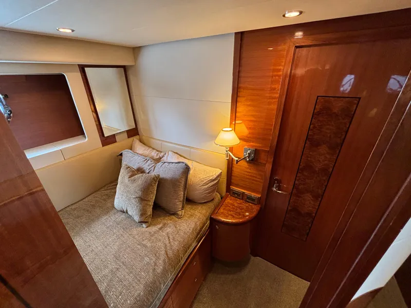 Slide: The Image of Luxurious cabin interior of 2010 Norseman 80 yacht with cozy bed and elegant wood finishes. - 48