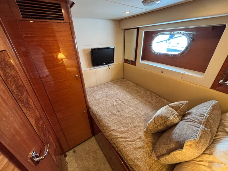 Slide: The Image of Cozy cabin interior of 2010 Norseman 80 yacht with bed, window, and TV. - 49