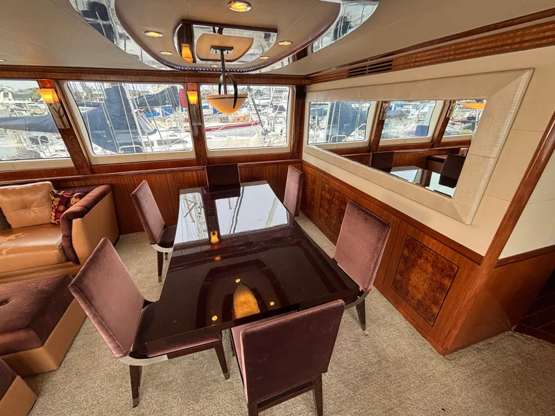 Slide: The Image of Luxurious dining area on a 2010 Norseman 80 yacht with elegant furnishings and marina view. - 6