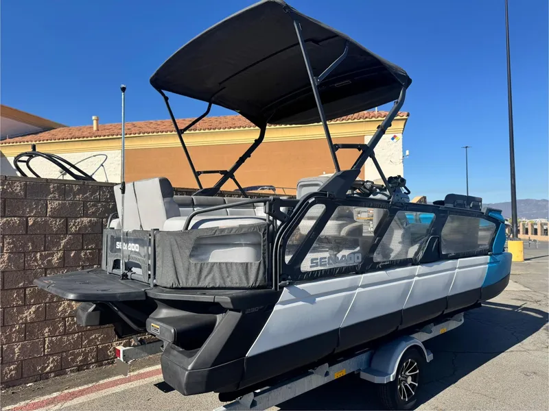Slide: The Image of 2023 Sea-Doo Switch Cruise 21 pontoon boat on trailer, parked outdoors. - 6