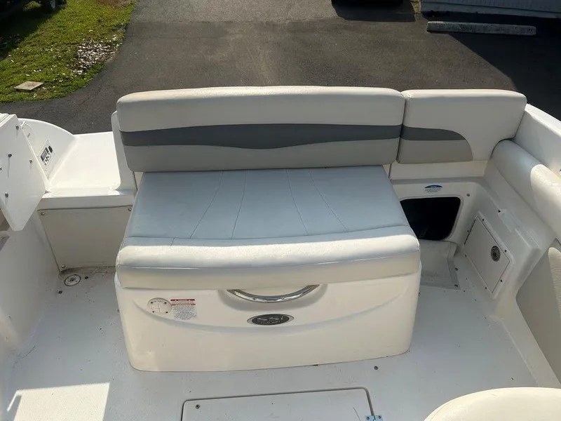 Slide: The Image of 2008 Chaparral 215 SSi boat interior with white seating and storage compartment. - 11