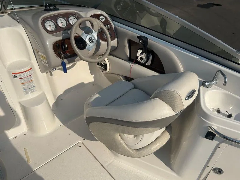 Slide: The Image of 2008 Chaparral 215 SSi boat interior with steering wheel, gauges, and seating. - 19