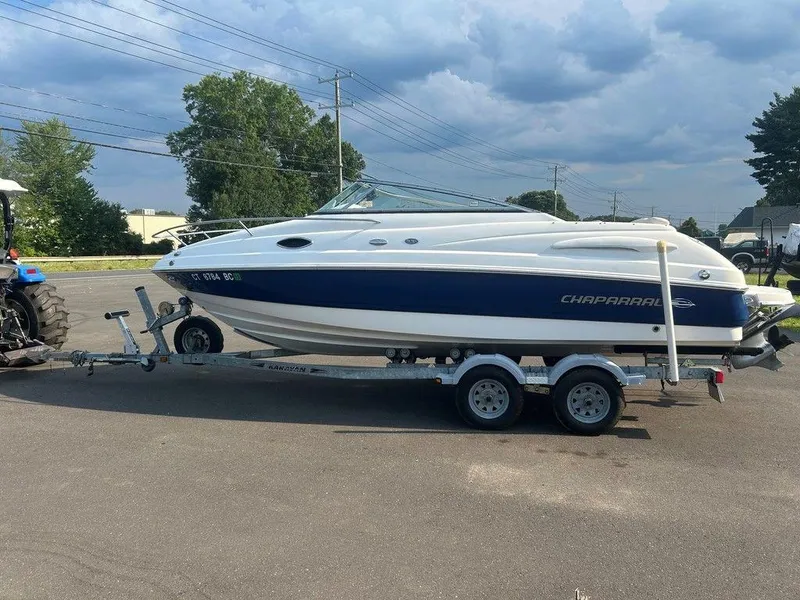 Slide: The Image of 2008 Chaparral 215 SSi boat on trailer, parked outdoors under cloudy sky. - 2