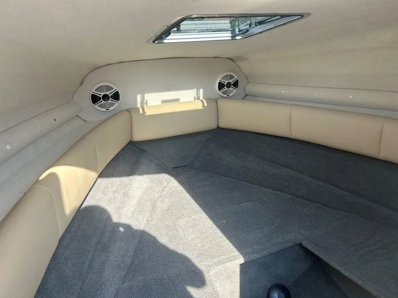 Slide: The Image of Interior cabin of 2008 Chaparral 215 SSi boat with beige seating and speakers. - 28