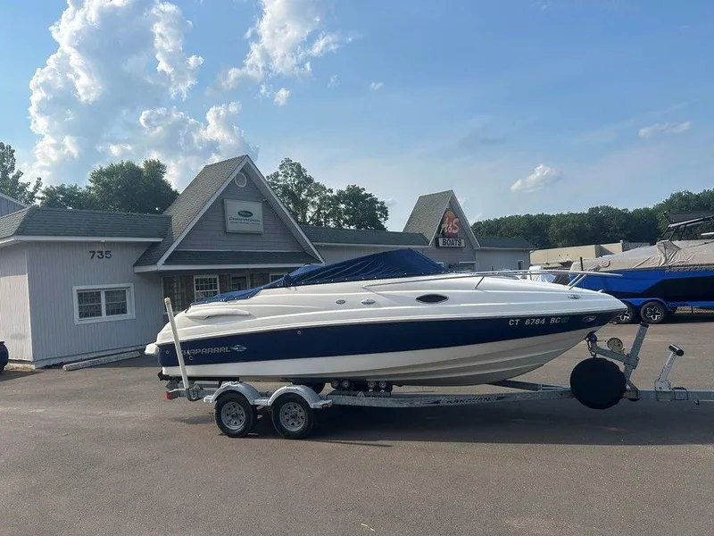 Slide: The Image of 2008 Chaparral 215 SSi boat on trailer outside dealership, clear sky background. - 6