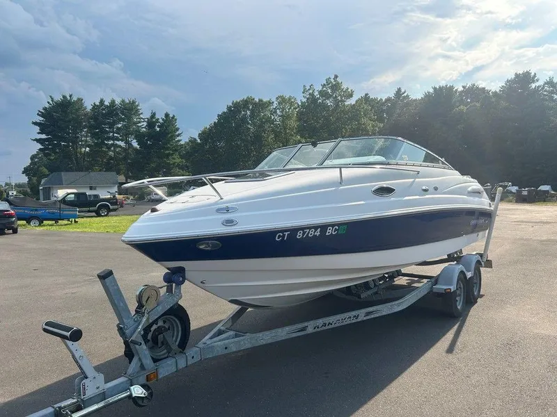 Slide: The Image of 2008 Chaparral 215 SSi boat on trailer, parked outdoors under a partly cloudy sky. - 8