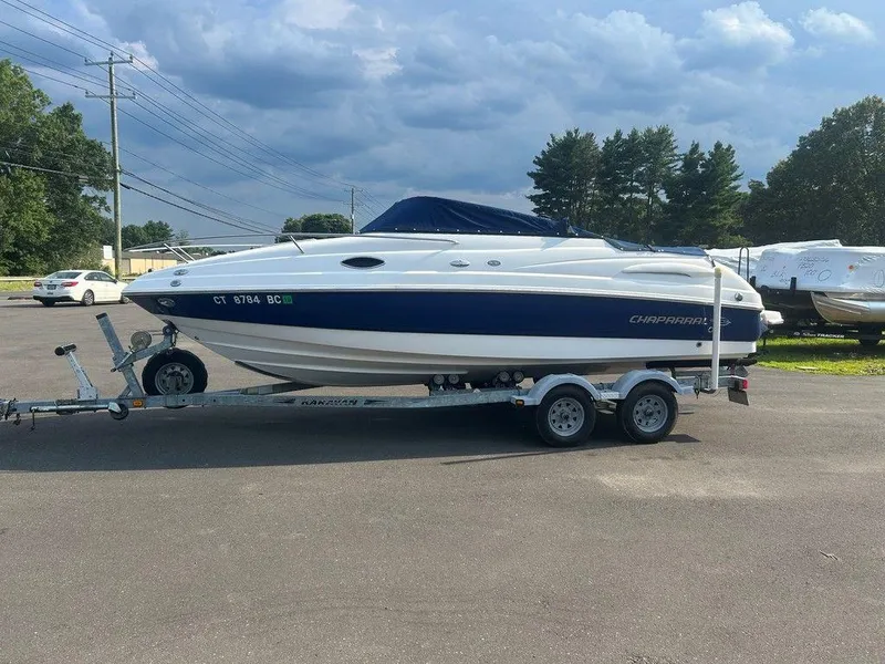 Slide: The Image of 2008 Chaparral 215 SSi boat on trailer, parked outdoors under cloudy sky. - 9