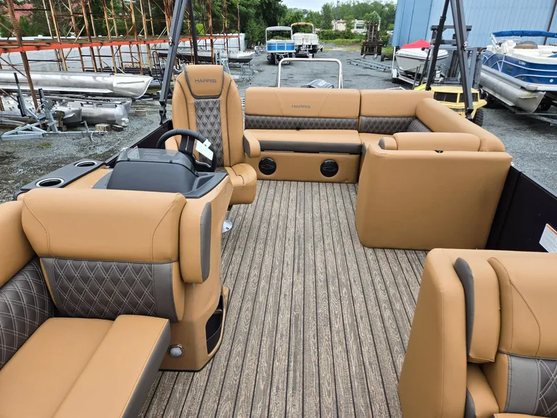 Slide: The Image of 2026 Harris Cruiser 210 pontoon boat with tan seating and wood-style flooring. - 11