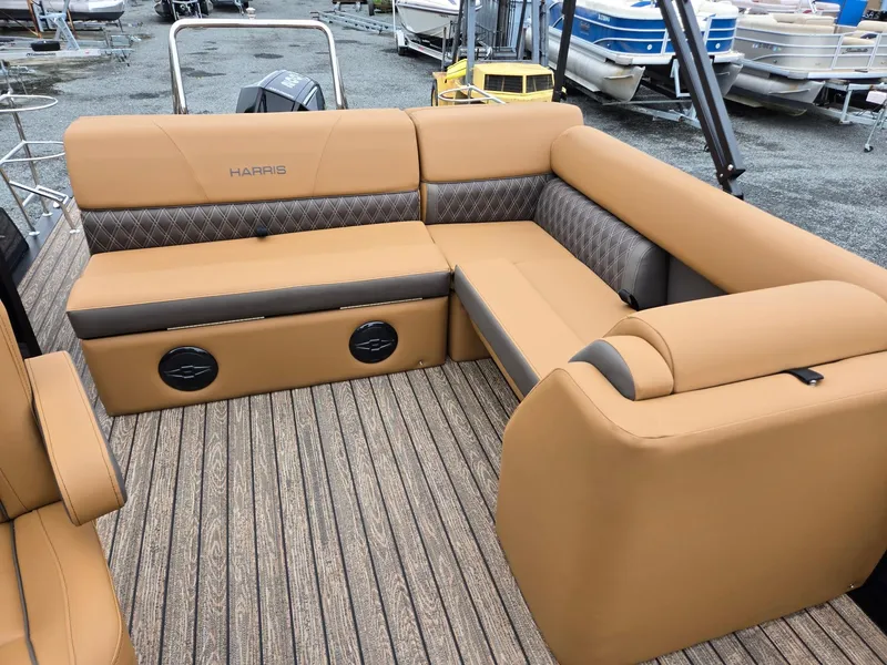 Slide: The Image of Luxurious seating on 2026 Harris Cruiser 210 pontoon boat with tan upholstery and wood-style flooring. - 15