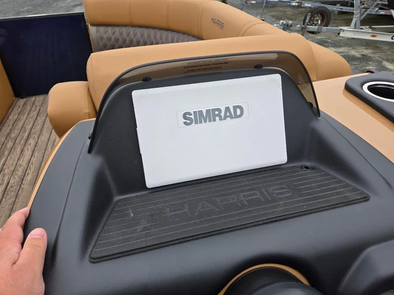 Slide: The Image of 2026 Harris Cruiser 210 dashboard with Simrad display and tan seating. - 18
