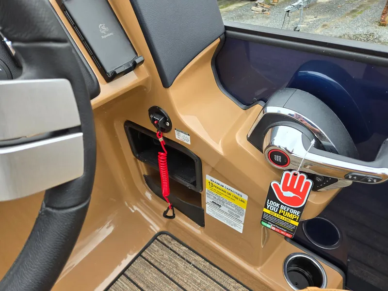 Slide: The Image of 2026 Harris Cruiser 210 dashboard with steering wheel, throttle, and safety warning tag. - 20