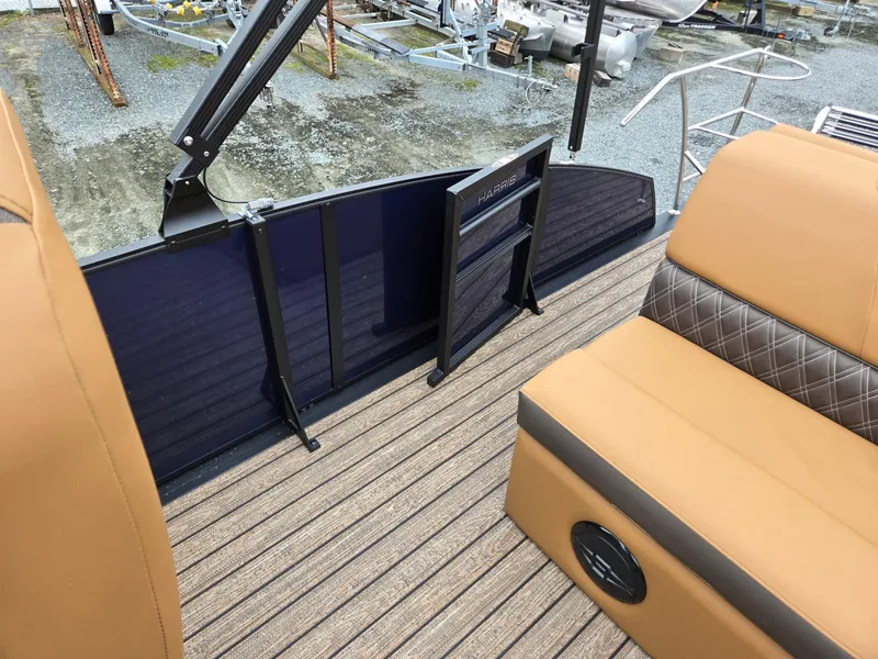 Slide: The Image of 2026 Harris Cruiser 210 boat interior with tan seating and wood-style flooring. - 21
