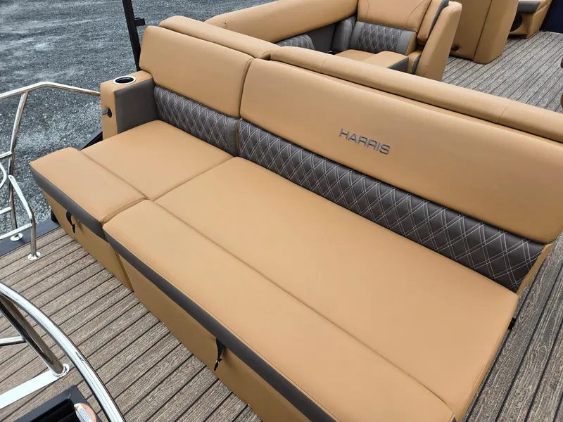 Slide: The Image of 2026 Harris Cruiser 210 boat with tan and gray seating, featuring diamond-patterned upholstery. - 26