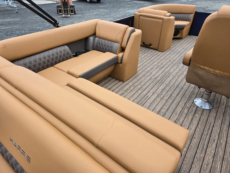 Slide: The Image of 2026 Harris Cruiser 210 interior with tan seating and wood-patterned flooring. - 28