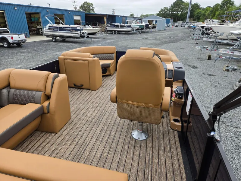 Slide: The Image of 2026 Harris Cruiser 210 pontoon boat interior with tan seating and wood-style flooring. - 29