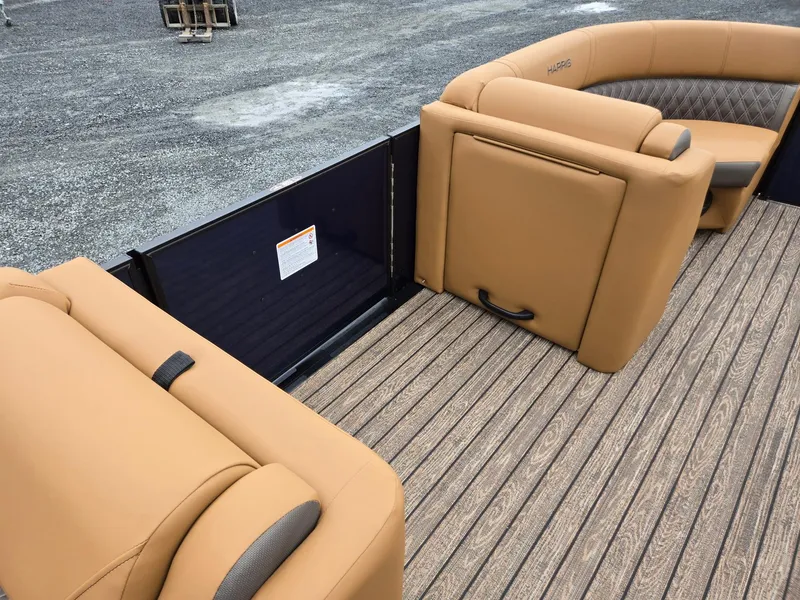 Slide: The Image of 2026 Harris Cruiser 210 boat interior with tan seating and wood-patterned flooring. - 31