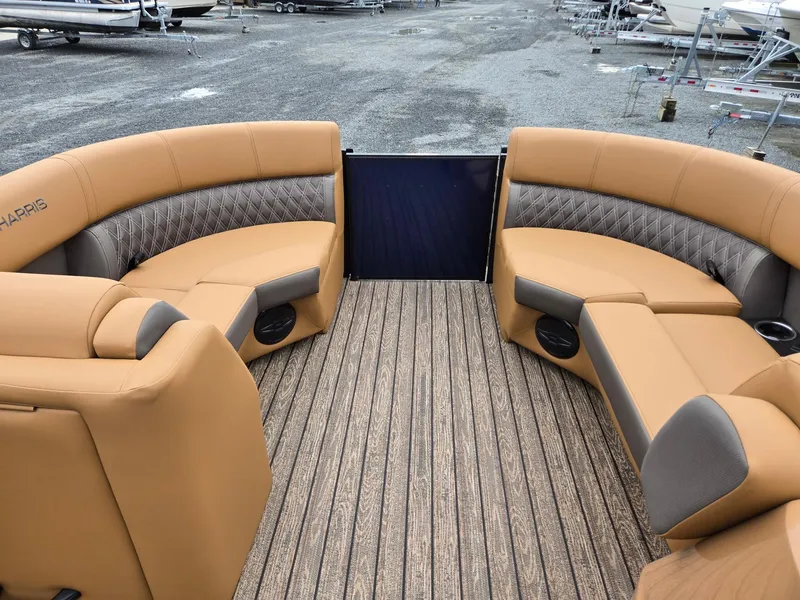 Slide: The Image of 2026 Harris Cruiser 210 boat interior with tan seating and wood-patterned flooring. - 33