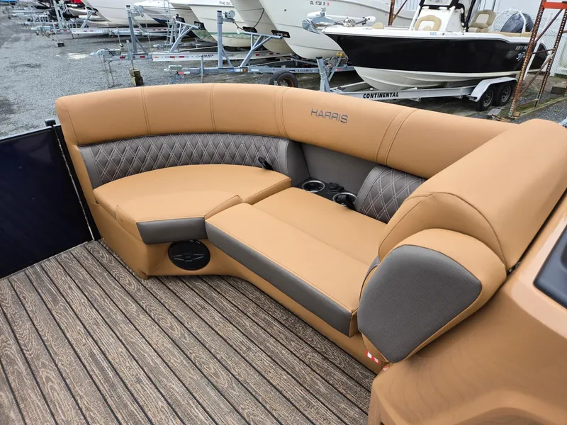 Slide: The Image of Luxurious seating on 2026 Harris Cruiser 210 boat, featuring tan upholstery and cup holders. - 34