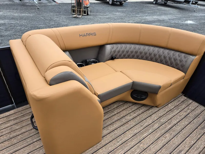 Slide: The Image of 2026 Harris Cruiser 210 boat interior with tan and gray seating on a wooden deck. - 35