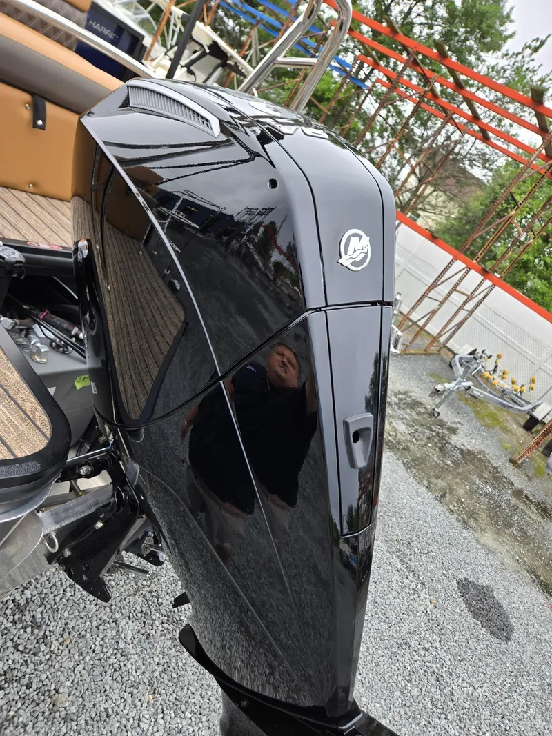 Slide: The Image of Sleek black outboard motor on 2026 Harris Cruiser 210 boat, reflecting surroundings. - 39