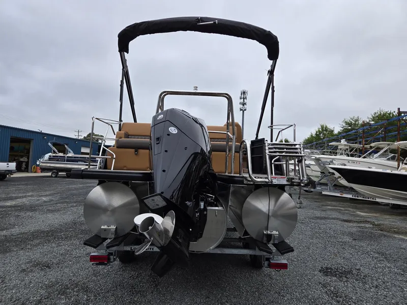 Slide: The Image of 2026 Harris Cruiser 210 pontoon boat with powerful outboard motor, parked on gravel lot. - 4