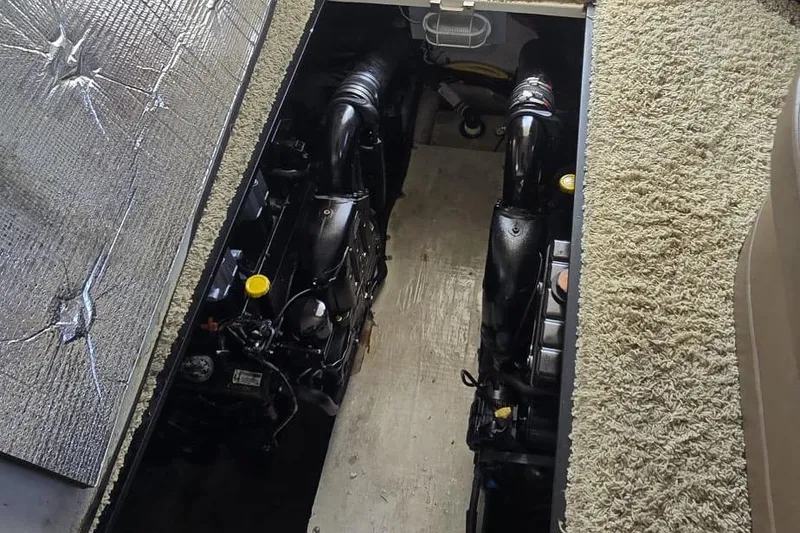 Slide: The Image of Engine compartment of a 2012 Meridian 341 Sedan, showcasing dual engines and carpeted flooring. - 10