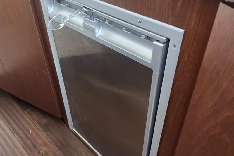 Slide: The Image of Built-in refrigerator on 2012 Meridian 341 Sedan yacht, with wooden cabinetry and stainless steel finish. - 15