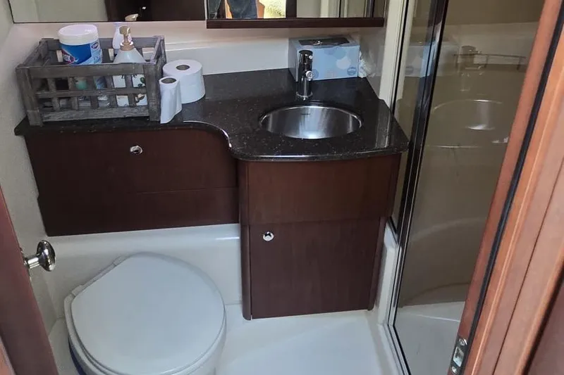 Slide: The Image of 2012 Meridian 341 Sedan bathroom with sink, toilet, and storage cabinet. - 17