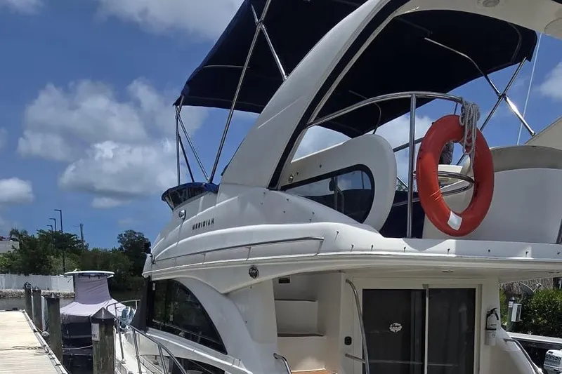 Slide: The Image of 2012 Meridian 341 Sedan yacht docked under a clear blue sky. - 2