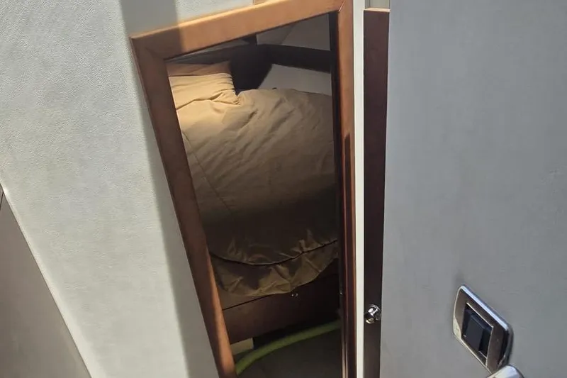 Slide: The Image of Interior view of a 2012 Meridian 341 Sedan cabin with bed and door. - 20
