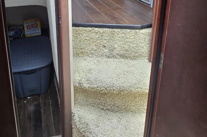 Slide: The Image of Carpeted stairs inside a 2012 Meridian 341 Sedan yacht, leading to a wooden floor area. - 21
