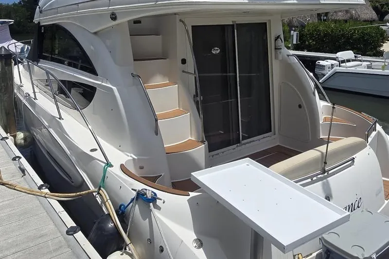 Slide: The Image of 2012 Meridian 341 Sedan yacht docked, featuring sleek design and outdoor seating area. - 3