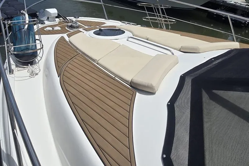 Slide: The Image of 2012 Meridian 341 Sedan yacht deck with sun loungers and wooden accents. - 31