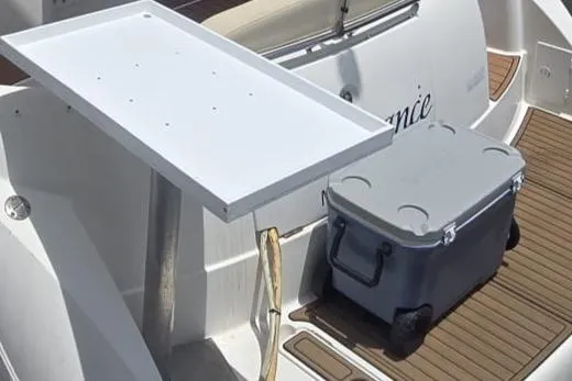 Slide: The Image of 2012 Meridian 341 Sedan boat with a white table and gray cooler on deck. - 4