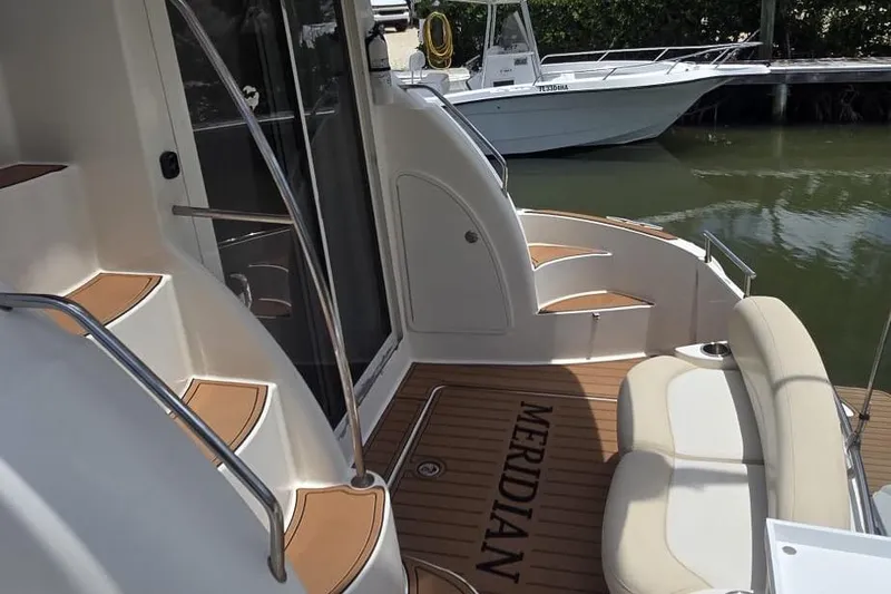 Slide: The Image of 2012 Meridian 341 Sedan yacht interior with elegant seating and teak flooring. - 5