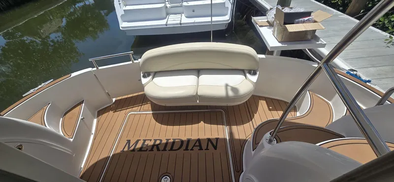 Slide: The Image of 2012 Meridian 341 Sedan yacht deck with seating and teak flooring. - 6