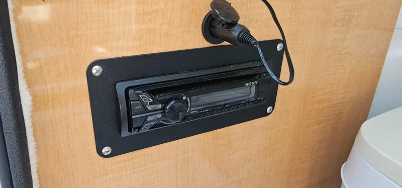 Slide: The Image of Sony stereo system installed on a 2014 Glastron GT 245 boat dashboard. - 13