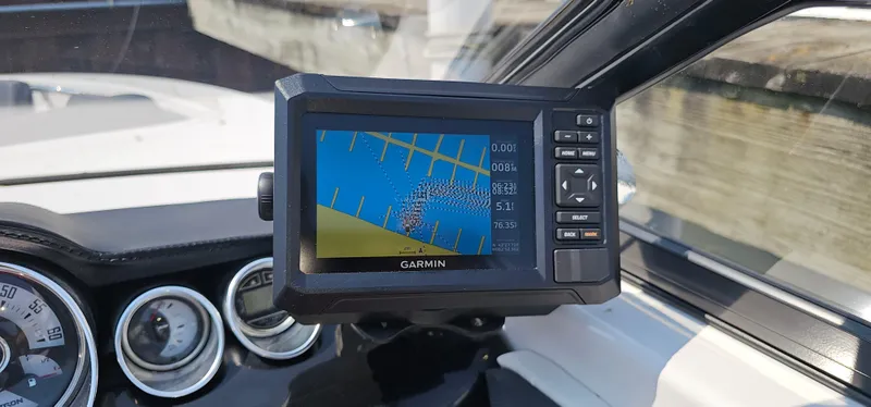 Slide: The Image of Garmin GPS display on 2014 Glastron GT 245 boat dashboard, showing navigation data. - 16