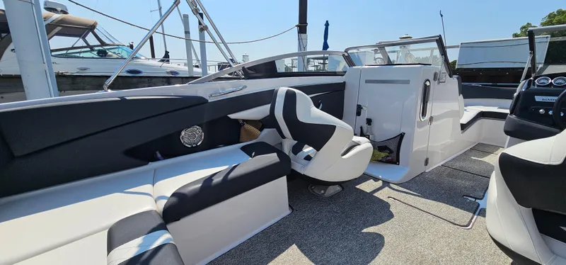 Slide: The Image of Interior of 2014 Glastron GT 245 boat with modern seating and dashboard. - 9