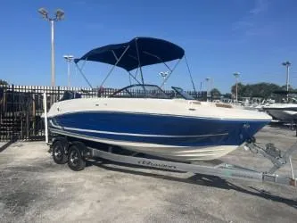 Slide: The Image of 2022 Bayliner VR6 boat on trailer with blue canopy in outdoor setting. - 3