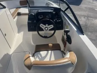 Slide: The Image of 2022 Bayliner VR6 boat cockpit with steering wheel and seating, featuring modern design elements. - 8