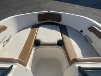 Slide: The Image of 2022 Bayliner VR6 boat interior with tan and white seating. - 9