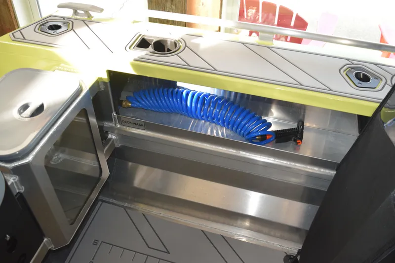 Slide: The Image of 2026 Stabicraft 1550 Fisher Offshore deck wash compartment with blue hose. - 11