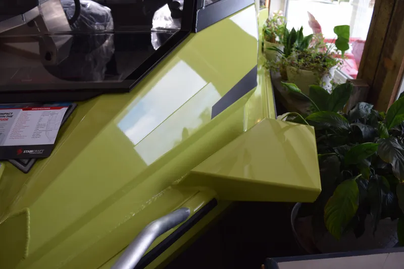 Slide: The Image of 2026 Stabicraft 1550 Fisher Offshore in showroom, surrounded by plants. - 17