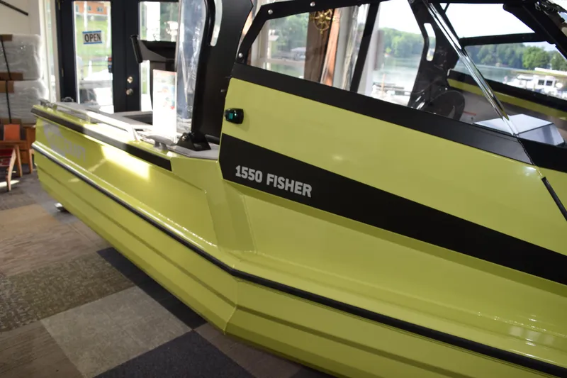 Slide: The Image of 2026 Stabicraft 1550 Fisher Offshore boat in showroom, lime green color. - 19